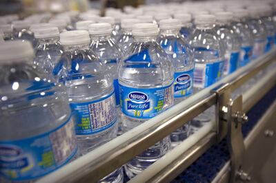 Bottles of Pure Life brand water move on the production line at the Nestle Waters Canada plant near Guelph, Ontario, Canada, on Friday, Jan. 16, 2015. Nestle, the world's largest food company, owns about 60 water brands including Pure Life, the world’s best-selling label. Photographer: Kevin Van Paassen/Bloomberg