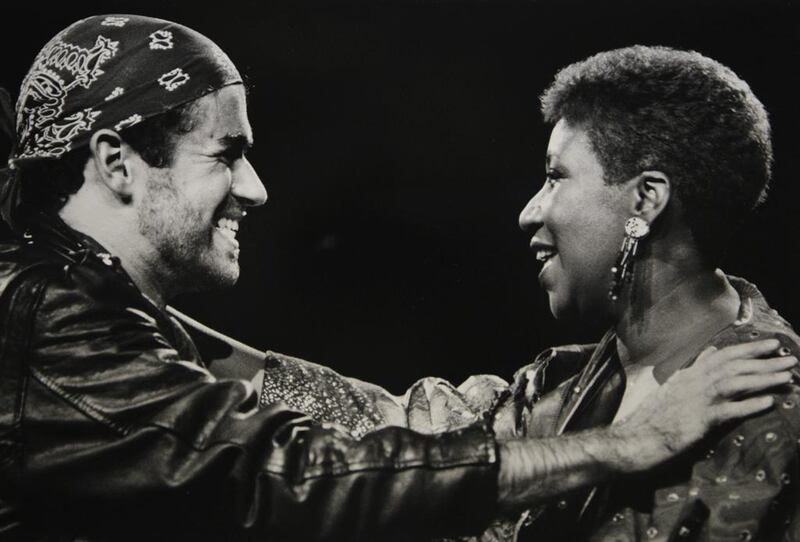 In this August 30, 1988, file photo, singing great Aretha Franklin, right, joins George Michael during his Faith World Tour in Auburn Hills, Michigan. Rob Kozloff, File / AP photo