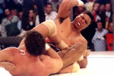 DENVER, CO - NOVEMBER 12:  Kickboxer Patrick Smith of Denver, CO tries to ward off a kick to the stomach by Toughman champ Ken Shamrock during the Ultimate Fighter Championships UFC 1 on November 12, 1993 at the McNichols Sports Arena in Denver, Colorado.  (Photo by Holly Stein/Getty Images)