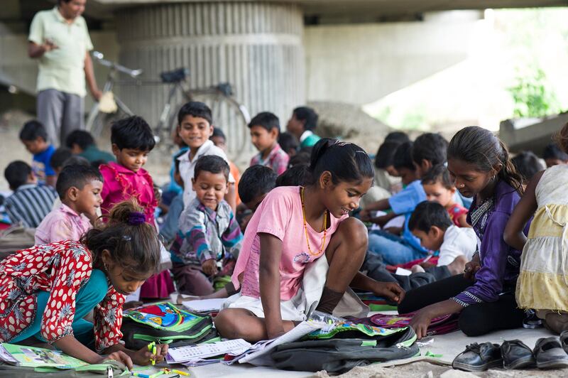 8th April 2013, Shakarpur, New Delhi, India.  L-R foreground: Mamta, Savitha Kumari (12, centre) and Kunti study at a makeshift school under a metro bridge near the Yamuna Bank Metro station in Shakarpur, New Delhi, India on the 8th April 2013. 

Rajesh Kumar Sharma (40), started this makeshift school a year ago. Five days a week, he takes out two hours to teach when his younger brother replaces him at his general store in Shakarpur. His students are children of labourers, rickshaw-pullers and farm workers. This is the 3rd site he has used to teach under privileged children in the city, he began in 1997 fifteen years ago. 

PHOTOGRAPH BY AND COPYRIGHT OF SIMON DE TREY-WHITE

+ 91 98103 99809
+ 91 11 435 06980
+44 07966 405896
+44 1963 220 745
email: simon@simondetreywhite.com