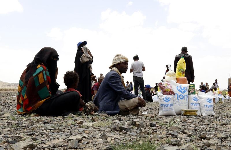 Displaced Yemenis receive food rations at a camp on the outskirts of Sana'a, Yemen. EPA
