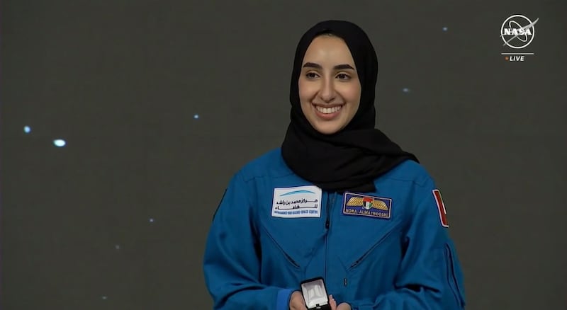 Nora Al Matrooshi holds up her silver pin, which is awarded to astronauts who have completed training but have yet to fly to space, during a graduation ceremony held at the Johnson Space Centre in Houston, Texas. Photo: Nasa TV