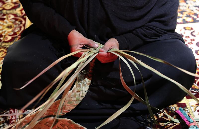 DUBAI, UNITED ARAB EMIRATES, Jan 09  – 2020 :- One of the lady making broom with palm leaves during the Al Shindagha Days culture festival held at Al Shindagha Heritage District in Dubai. (Pawan Singh / The National) Photo essay for Weekend. Story by Katy Gillett 