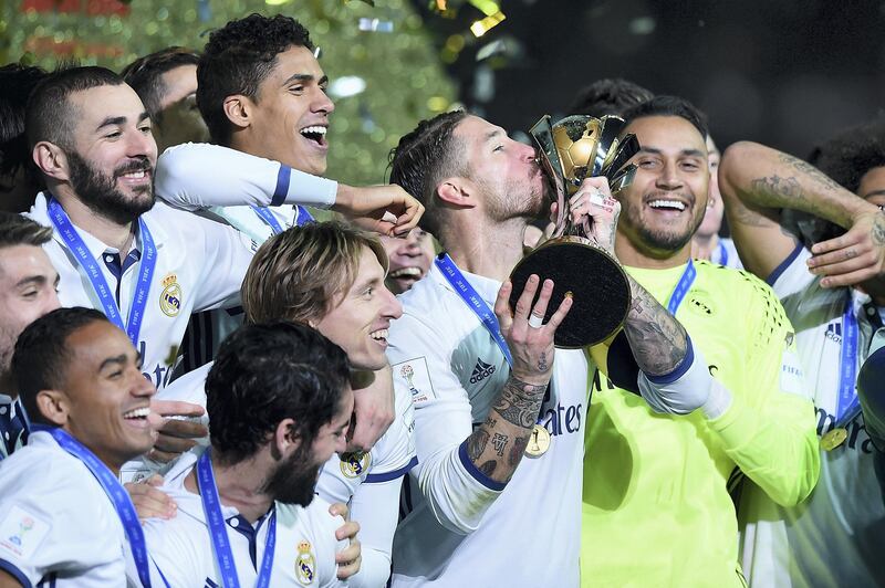 YOKOHAMA, JAPAN - DECEMBER 18:  Sergio Ramos of Real Madrid kisses the trophy as Real Madrid celebrate victory during the FIFA Club World Cup final match between Real Madrid and Kashima Antlers at International Stadium Yokohama on December 18, 2016 in Yokohama, Japan.  (Photo by Matt Roberts/Getty Images)