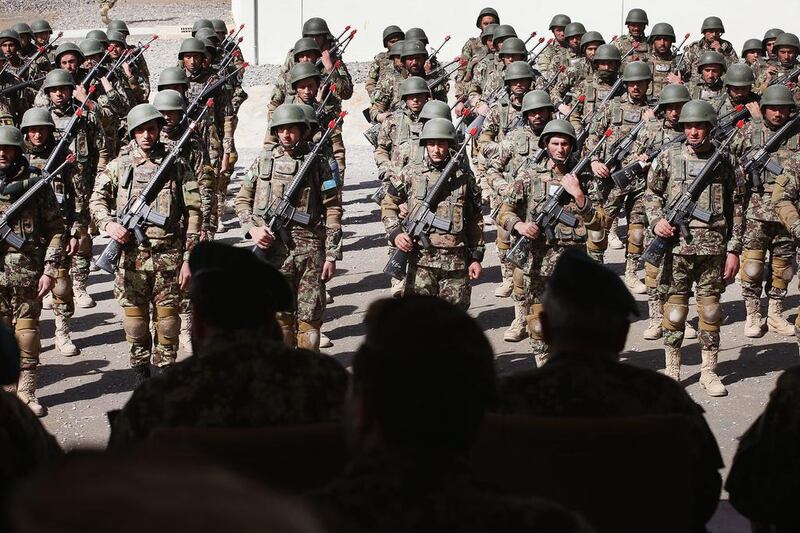 Senior officers from the Afghan, American and Turkish military watch a basic training graduation ceremony at the Afghan National Army’s combined fielding centre in Kabul. Scott Olson / Getty / March 18, 2014