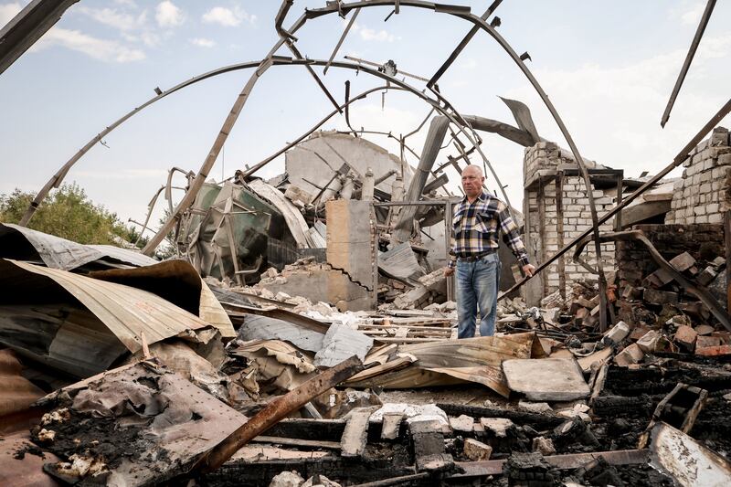 A Ukrainian farmer surveys a destroyed grain depot on his land near the frontline town of Orikhiv, Zaporizhzhia region. EPA