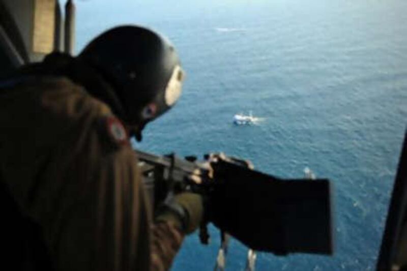 A French soldier scans the coast of Djibouti as part of an assignment to escort commercial ships in the Gulf of Aden.