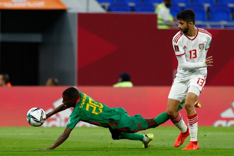Mauritania midfielder Oumar M'Bareck, left, falls following a tackle with the UAE defender Mohamad Al Attas.