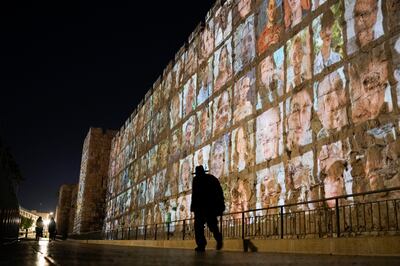 Photographs of Israeli hostages being held by Hamas militants are projected on the walls of Jerusalem's Old City. AP