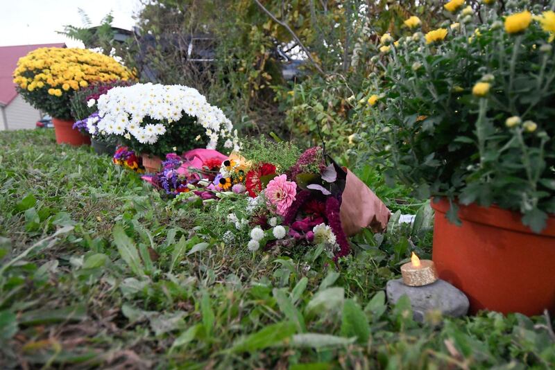 Flowers are placed at a roadside memorial. AP Photo