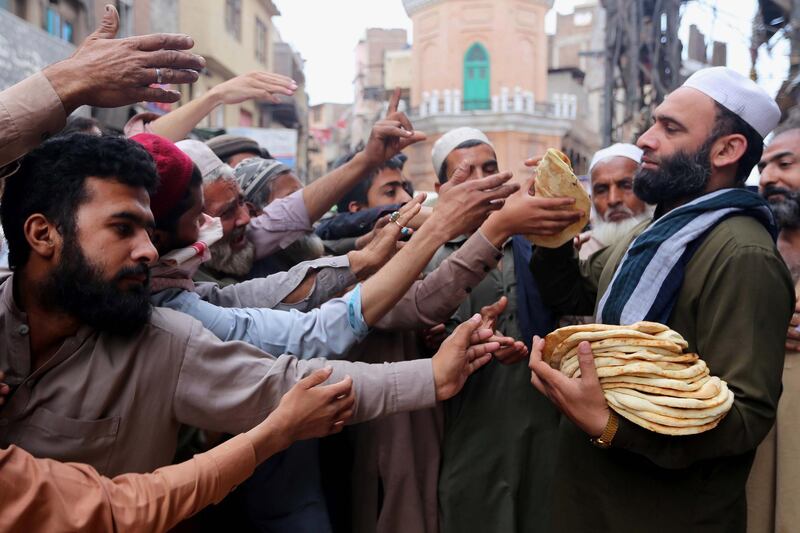 Crowds gather to receive free bread during the holy month in Peshawar, Pakistan. EPA