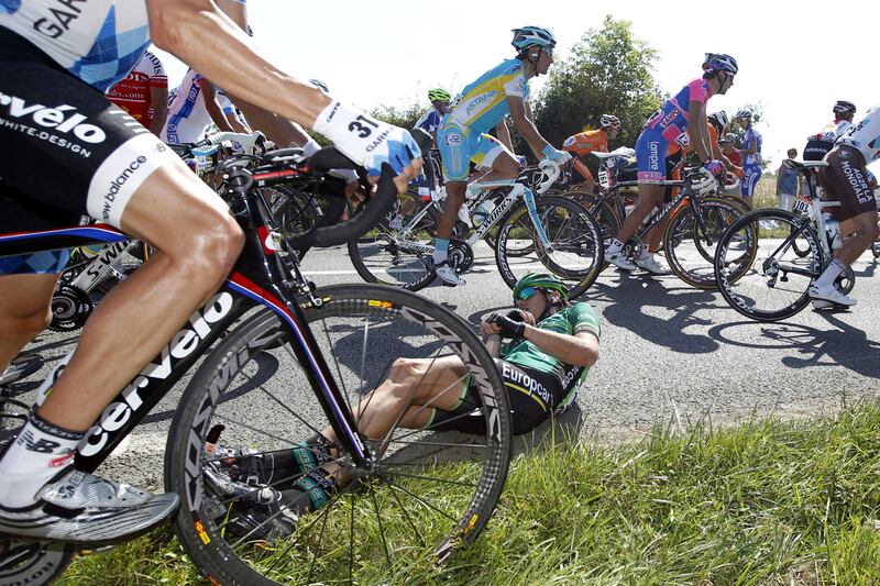 Wounded Vincent Jerome, centre, is on the ground after crashing in the pack during the 191.5km first stage of the 2011 Tour de France between Fromentine La Barre-de-Monts and Monts des Alouettes in Les Herbiers.