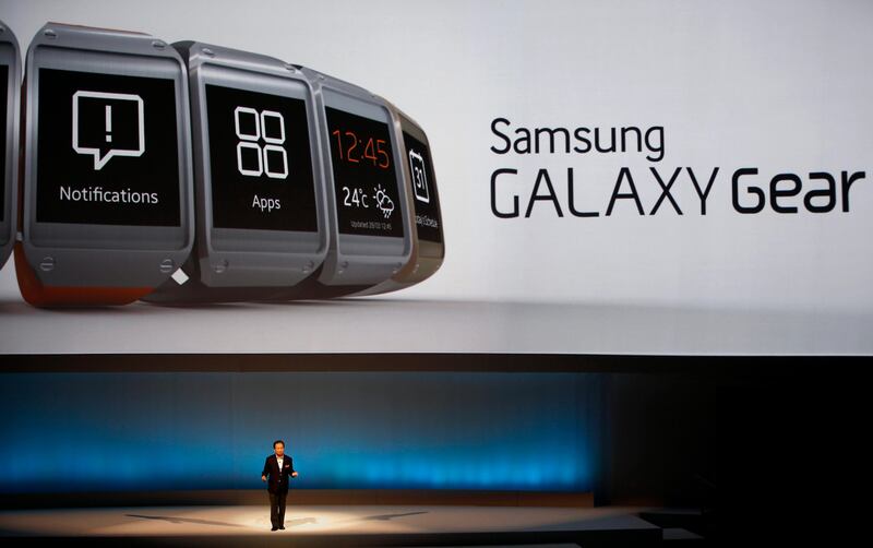 JK Shin, head of Samsung Mobile Communications, presents the Samsung Galaxy Gear in Berlin, Germany, Wednesday, Sept. 4, 2013. Samsung has unveiled a highly anticipated digital wristwatch well ahead of a similar product expected from rival Apple. The so-called smartwatch is what some technology analysts believe could become this year's must-have holiday gift. Samsung unveiled the Galaxy Gear on Wednesday in Berlin ahead of the annual IFA consumer electronics show.  (AP Photo/Michael Sohn) *** Local Caption ***  Germany Samsung Gadget Show.JPEG-02d5b.jpg