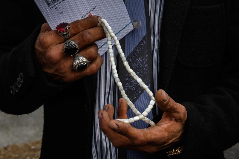 Omar Nabi, 43, holds prayer beads after the funeral of his father. AFP