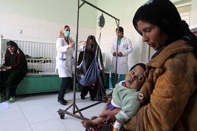 An Afghan woman and her child wait to receive medical treatment at a hospital in Herat, Afghanistan. EPA