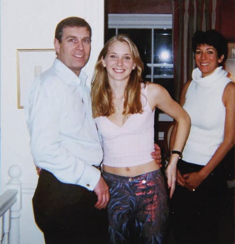 Virginia Giuffre has said that this photo of her posing with Prince Andrew was taken at Ghislaine Maxwell's London home. AFP