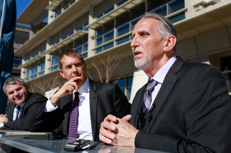 In this Feb. 15, 2018 file photo, Craig Coley, right, accompanied by his attorney's Ron Kaye, center, and Nick Brustin, left, talks with reporters in Sacramento, Calif. Coley spent 39 years in prison for a murder he didn't commit. The city of Simi Valley, California, has reached a $21 million settlement with Coley, who was wrongly imprisoned for nearly 40 years in the killing of his girlfriend and her 4-year-old son. (AP Photo/Rich Pedroncelli, File)