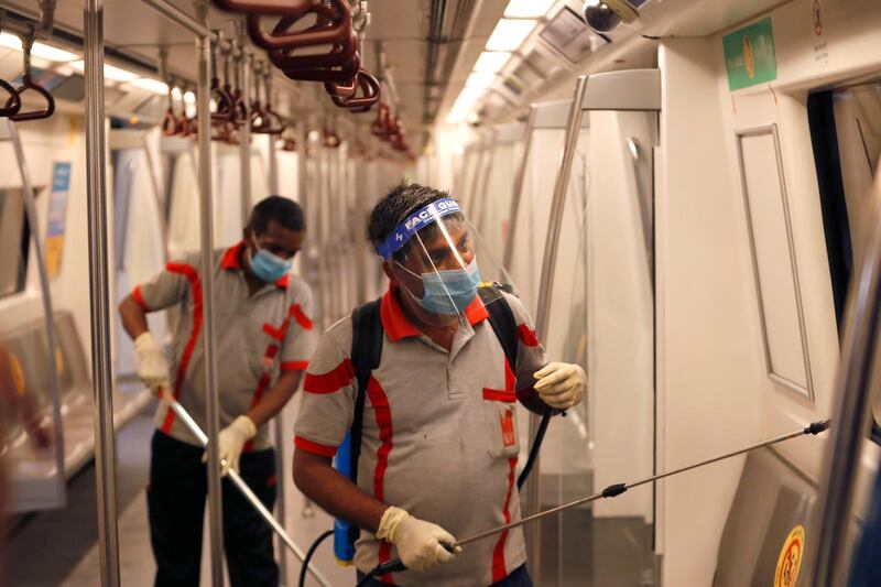 Workers sanitise a metro coach in New Delhi, India.  AP Photo