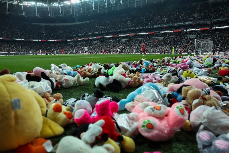 Toys at side of the pitch thrown by fans for children affected by earthquake during a Turkish Super League match between Besiktas and Antalyaspor. AP