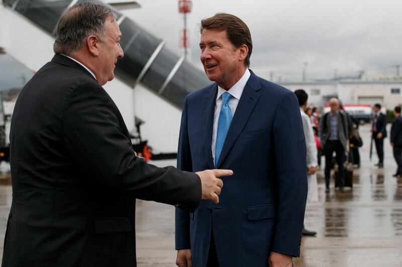 US Secretary of State Mike Pompeo (L) talks with US Ambassador to Japan Bill Hagerty as he arrives in Osakaahead of the G20 summit. AFP