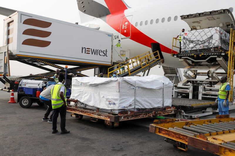 Workers unload boxes of AstraZeneca-Oxford vaccines at the airport in Accra, Ghana. Reuters