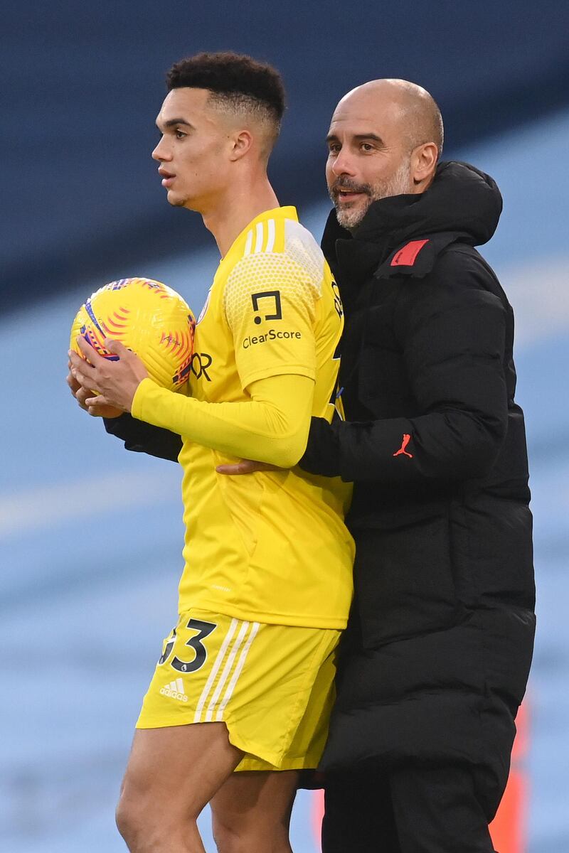 City manager Pep Guardiola and Antonee Robinson of Fulham. Getty