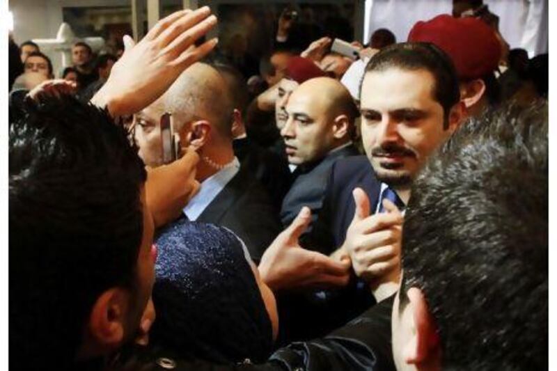 Saad Hariri, second from right, greets his supporters in Beirut yesterday.