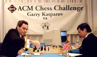 World chess champion Garry Kasparov, L, takes a pawn in the opening minutes of a six-game, six-day chess match against IBM's "Deep Blue" computer in Philadelphia 10 February. Feng-hsiung Hsu, R, the principal designer of "Deep Blue," keys a move into the computer. The computer, capable of computing 200 million positions per second, is powerful enough to be comparable to Kasparov's level of play.  AFP PHOTO Tom MIHALEK (Photo by TOM MIHALEK / AFP)