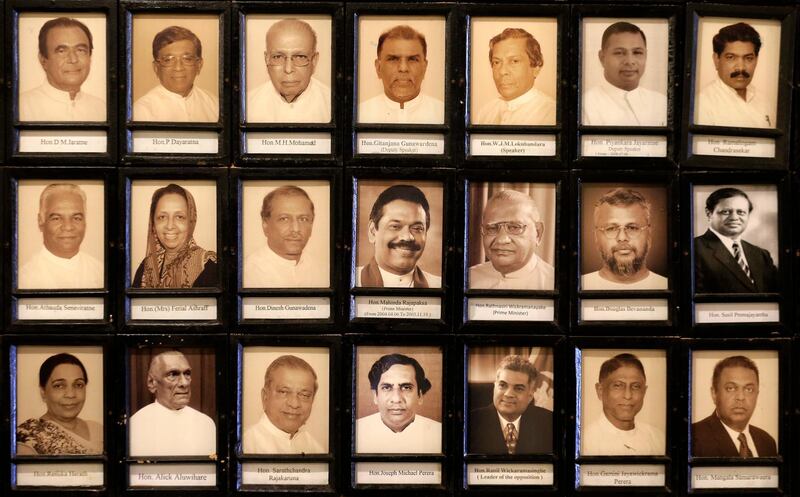 Portraits of Sri Lankan MPs including the newly appointed prime minister Mahinda Rajapaksa, centre, and sacked prime minister Ranil Wickeremesinghe, third from right in the bottom, are seen in the parliament in Colombo, Sri Lanka. AP Photo