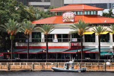 Law enforcement boats patrol the St. Johns River at The Jacksonville Landing after a mass shooting during a video game tournament at the riverfront mall, Sunday, Aug. 26, 2018, in Jacksonville, Fla. (Will Dickey/The Florida Times-Union via AP)