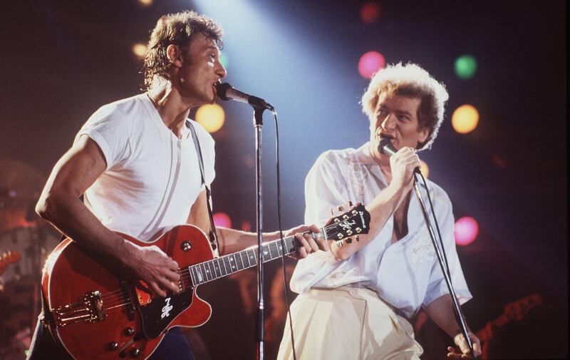 (FILES) This file photo taken on April 2, 1985 shows French singers Eddy Mitchell (R) and Johnny Hallyday performing at the stadium om Bourges during the 9th edition of the Printemps de Bourges.
France's best-known rock star Johnny Hallyday has died aged 74 after a battle with lung cancer, his wife Laeticia told AFP on December 6, 2017. / AFP PHOTO / Frank PERRY