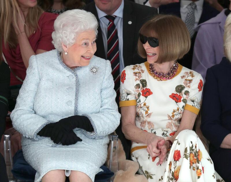 A new definition of the term 'power front row': Britain's Queen Elizabeth II sits next to 'Vogue' Editor-in-Chief Anna Wintour as they view Richard Quinn's runway show before presenting him with the inaugural Queen Elizabeth II Award for British Design. Yui Mok / Reuters