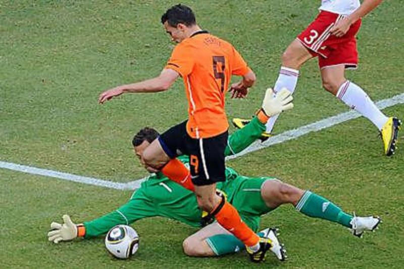 Thomas Sorensen keeps out Holland's Robin van Persie in the Group E opener.