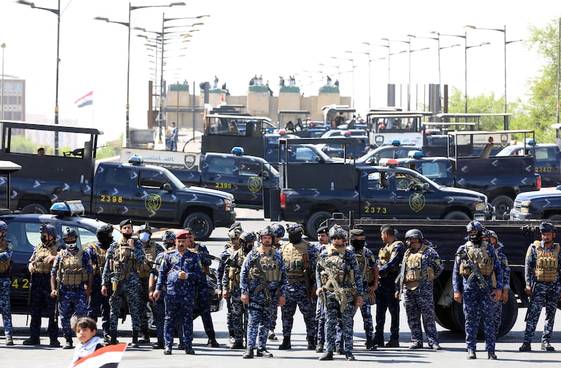 Security forces block a road as anti-government protesters try to enter the Green Zone of Baghdad. EPA 