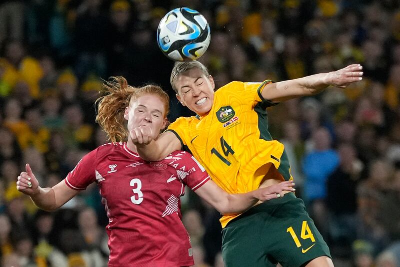 Denmark's Stine Ballisager and Australia's Alanna Kennedy challenge for the ball. AP