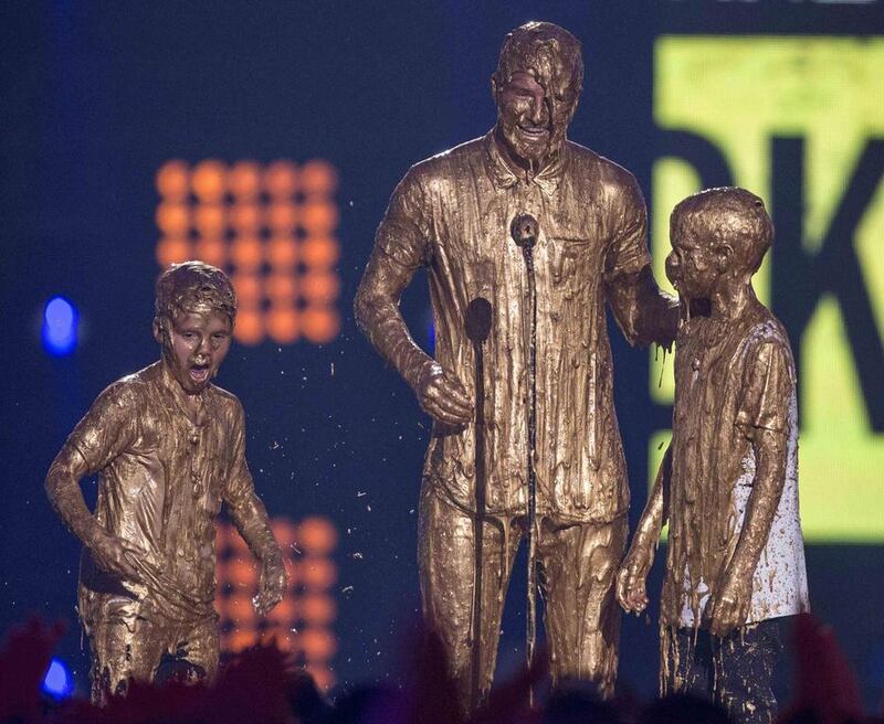 Former football player David Beckham gets “slimed” as he accepts the Legend Award with sons Cruz, left, and Romeo during the inaugural 2014 Nickelodeon Kids’ Choice Sports awards at UCLA’s Pauley Pavilion in Los Angeles, California on July 17, 2014. Mario Anzuoni / Reuters