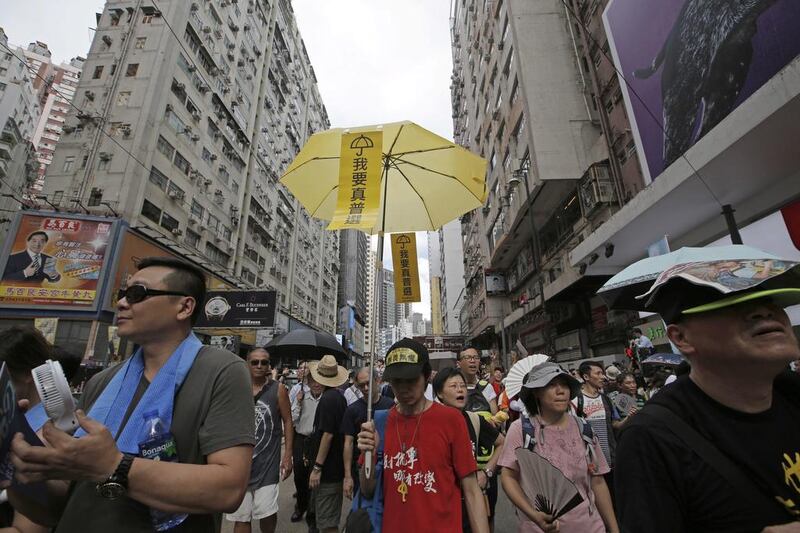 A protester holds an umbrella with Chinese words "I want genuine universal suffrage" during  an annual pro-democracy protest in Hong Kong on  July 1, 2016. Kin Cheung / Associated Press 