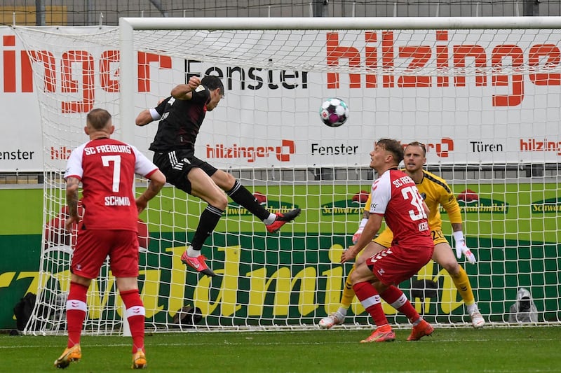 Robert Lewandowski heads towards goal but his effort is saved by Freiburg goalkeeper Mark Flekken. AFP
