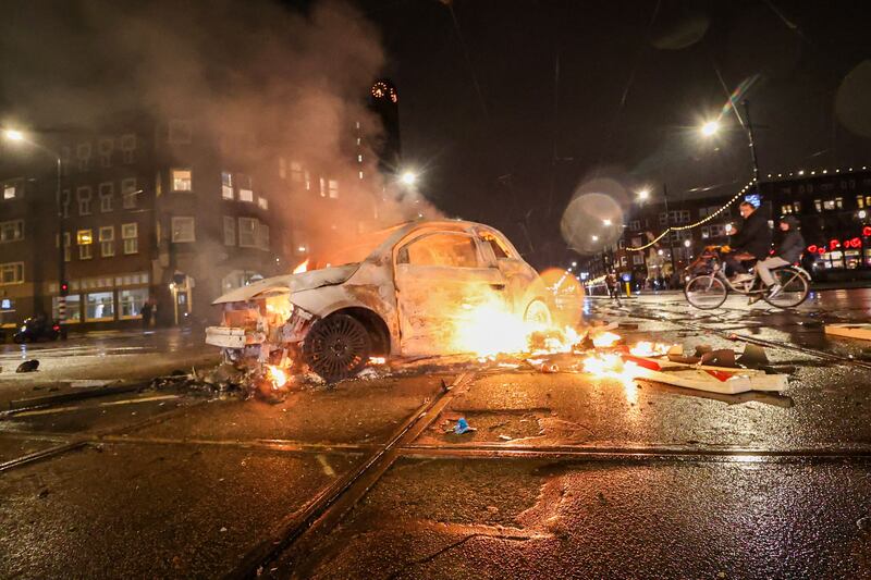 A car set alight by rioters at the Mercatorplein, in Amsterdam, the Netherlands. AFP