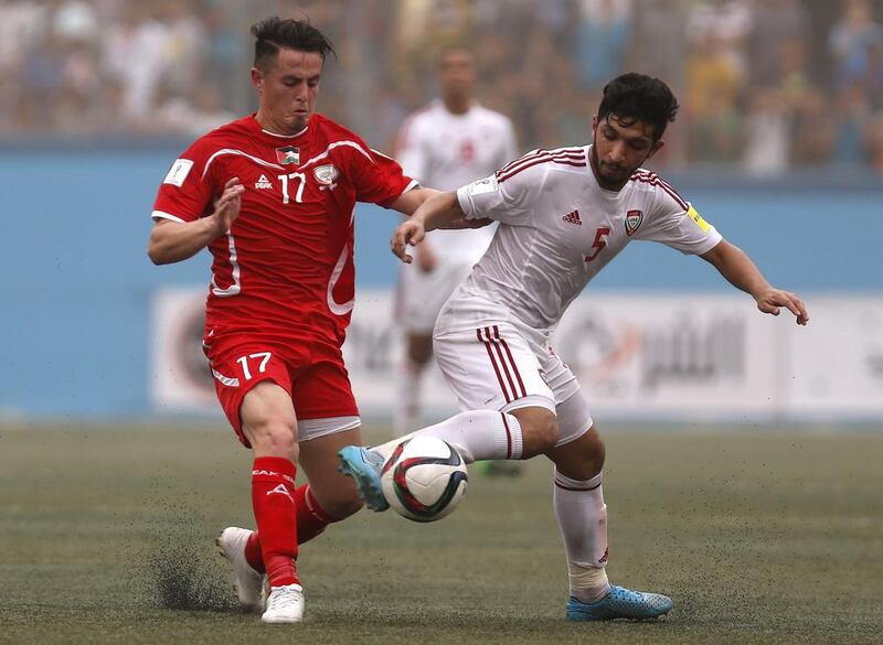 Palestine’s Pablo Bravo (L) vies for the ball with UAE midfielder Amer Abdulrahman during their 2018 World Cup qualifying match at the Faisal Al Husseini Stadium, on September 8, 2015 in the West Bank town of Al Ram. Ahmad Gharabli / AFP