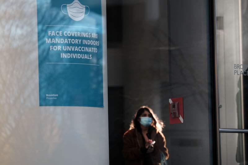 A sign asking people to wear face coverings in a building in Manhattan as the newly discovered Omicron variant appears in countries around the world. AFP
