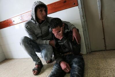 Relatives of 27-year-old Palestinian farmer Omar Samour, who was killed earlier in the day by Israeli tank fire, mourn in the hallway of the morgue of a hospital in Khan Yunis in the southern Gaza strip on March 30, 2018.
Local witnesses said Samour was working his land near the border when the shells hit,
while an Israeli army spokesman reported that "two suspects approached the security fence along the southern Gaza Strip and began operating suspiciously.
The shelling came just hours before the opening of large protest camps near the border, which have prompted the Israeli army to deploy reinforcements, including more than 100 special forces snipers, for fear of mass attempts to break through the security fence. / AFP PHOTO / SAID KHATIB