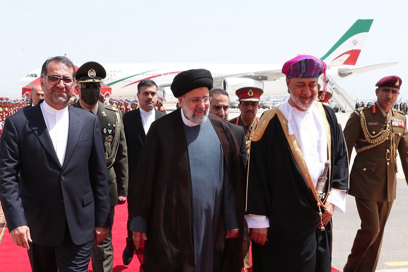 Oman's Sultan Haitham with Iranian President Ebrahim Raisi (C) at the airport in Muscat on Monday. EPA