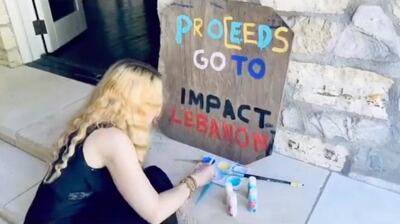 Madonna paints a sign for her family's art sale, which is raising money for Impact Lebanon. Instagram / Madonna 
