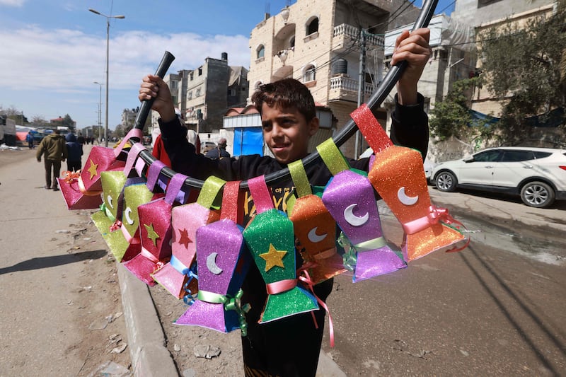 A displaced Palestinian child sells handmade Ramadan lanterns in Rafah. AFP