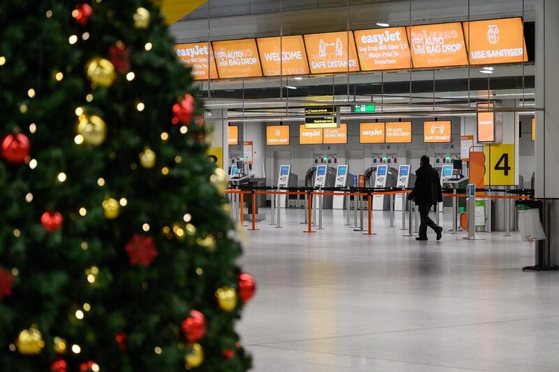 LONDON, ENGLAND - NOVEMBER 27: A person walks past the Christmas tree in the near-empty North Terminal at Gatwick Airport on November 27, 2020 in London, England. The airport will provide the PCR and swab tests, allowing passengers to travel to destinations which require them to prove they are Covid-free. Due to the COVID-19 pandemic, the number of travellers has fallen dramatically. During the period between July and September, the airport registered an 86% drop in passengers compared to the same period in 2019. The service, provided by ExpressTest, charges Â£60 per passenger flying from Gatwick, or Â£99 for general members of the public. (Photo by Leon Neal/Getty Images)