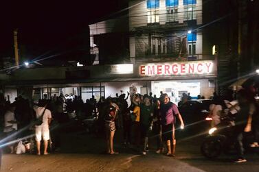 People are seen receiving assistance outside a hospital in Kidapawan City, after the earthquake. Reuters