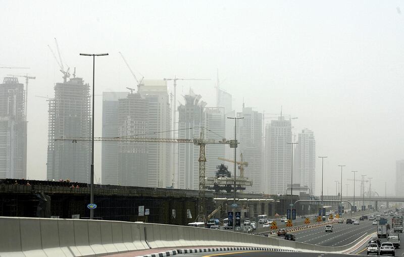 Scores of buildings under construction along the new subway line are seen on June 15, 2008 through a layer of haze as temperatures soared in the Gulf emirate of Dubai. The Gulf's booming construction industry is feeling the heat of soaring materials costs and labour shortages amid concern that supply pressures coud delay the completion of projects.    AFP PHOTO/MARWAN NAAMANI (Photo by MARWAN NAAMANI / AFP)