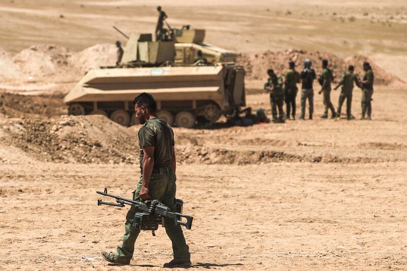 Iraqi pro-government forces advance towards the Unesco-listed ancient city of Hatra, south-west of Mosul, during an offensive to retake the area from ISIS fighters, on April 26, 2017.