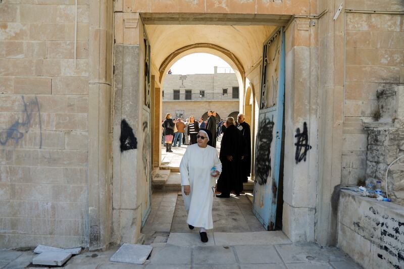 A nun walks in the monastery's courtyard, a historical Chaldean Catholic Church that was reconstructed after being destroyed by ISIS militants. Reuters